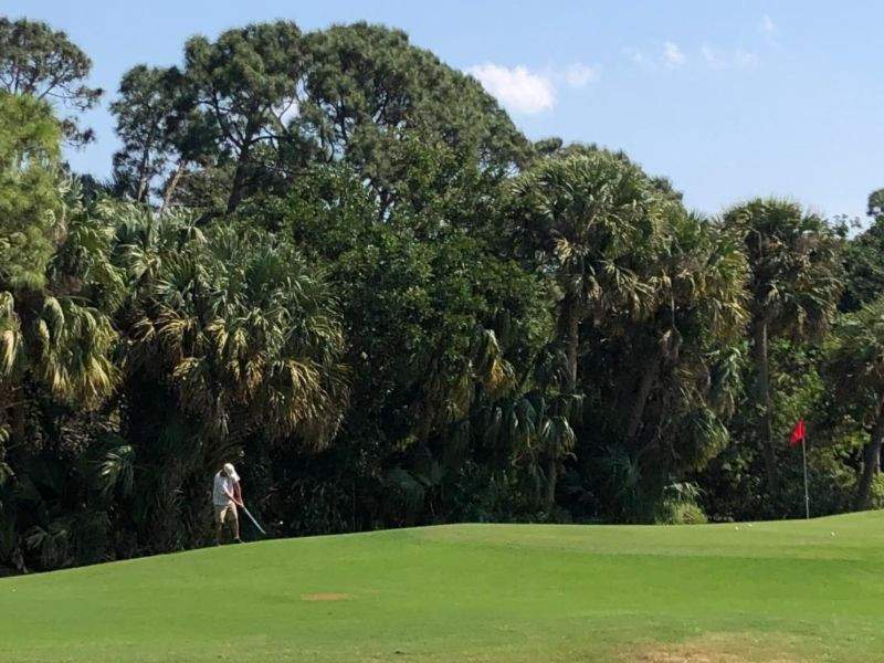 A Golf Village resident works on his short game.