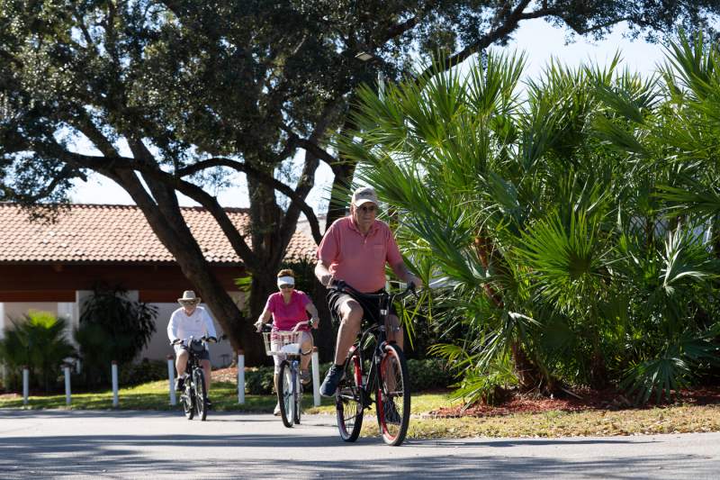 Three people biking. 